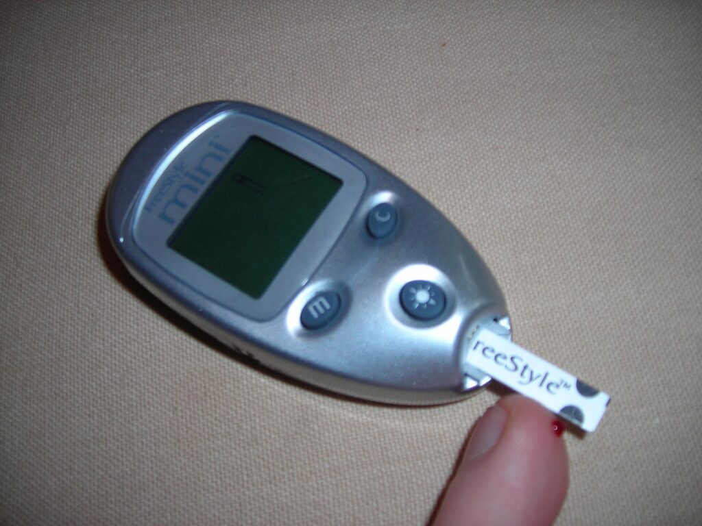 Person checking a glucose monitor reading