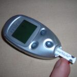 Person checking a glucose monitor reading